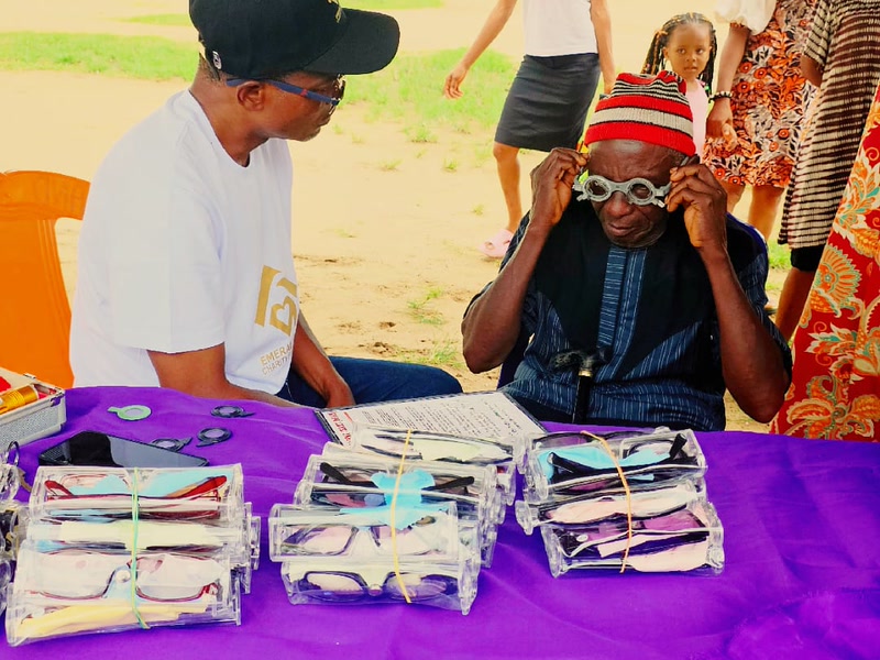 Free eye exam in progress as residents are fitted for reading glasses
