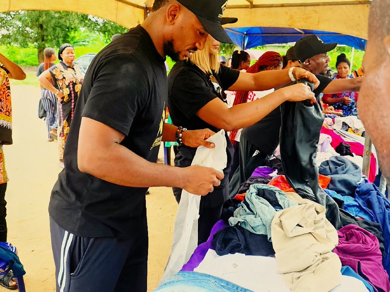 Volunteers distributing donated clothing to families in Uyo