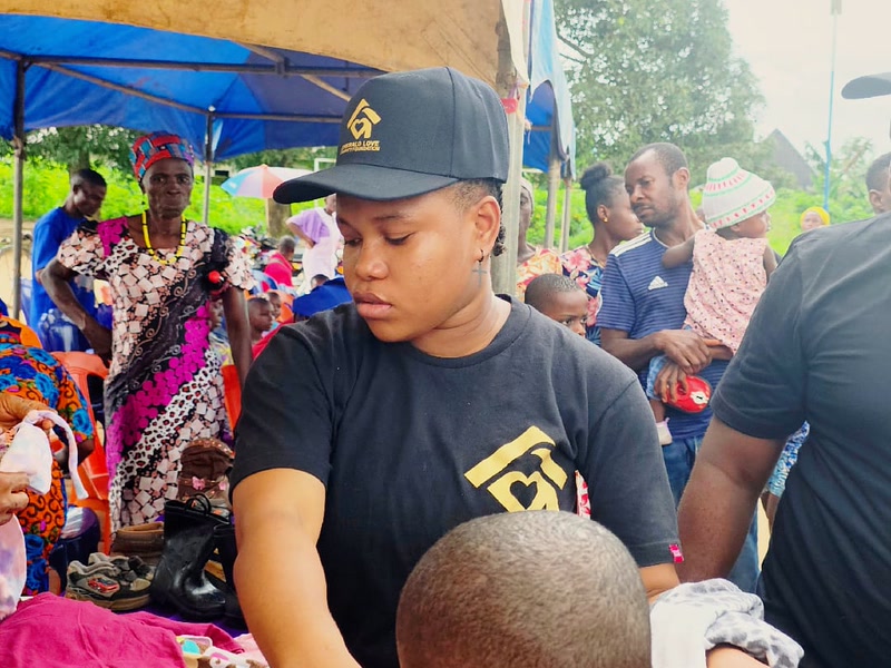 Volunteers helping children choose clothing at the Uyo giveaway
